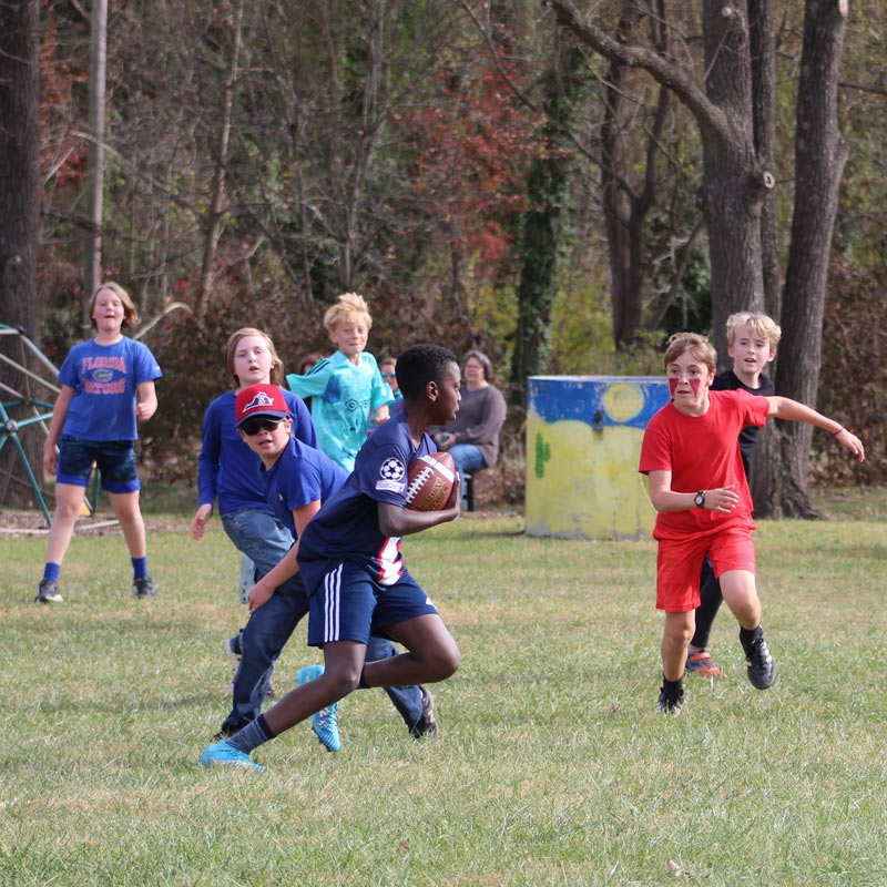 A diverse mix of students play football at Community School in Hollins, Virginia.