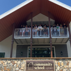 Students standing on the balcony of the new building.